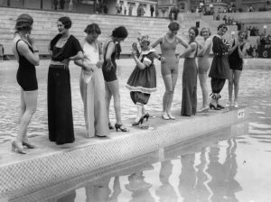 Young women presenting fashion on a catwalk in the water. Around 1930