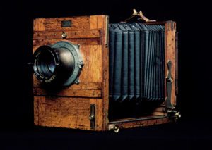 Old camera. The lens is at left, directing light onto the plate at the back of the concertina-like extension