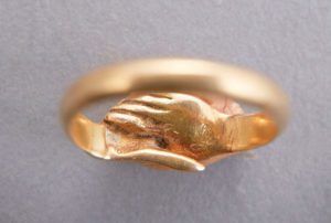 Gold ring with two hands entwined. National Maritime Museum, Greenwich London