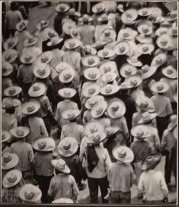 workmen parade seen from top sea of hats black and white photo by Tina Modotti