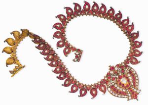 An Indian ruby and diamond necklace with a centre-piece designed as a double-peacock, circa 1900 -