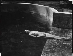 Nude woman photo by Edward Weston floating in a pool