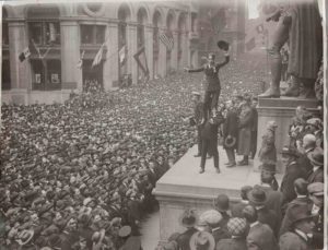Douglas Fairbanks Boosting Charlie Chaplin to Boost the Liberty Loan in Front of the Sub-Treasury Building: All Wall Street Looking on with Approval, 1918 - 0151742