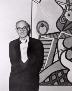 Alfred H. Barr, Jr., Director Emeritus of the Museum, wearing a paper tie designed for him by Pablo Picasso, at the opening of the exhibition 'Picasso: 75th Anniversary', MoMA, NY, May 1957. - 0132181