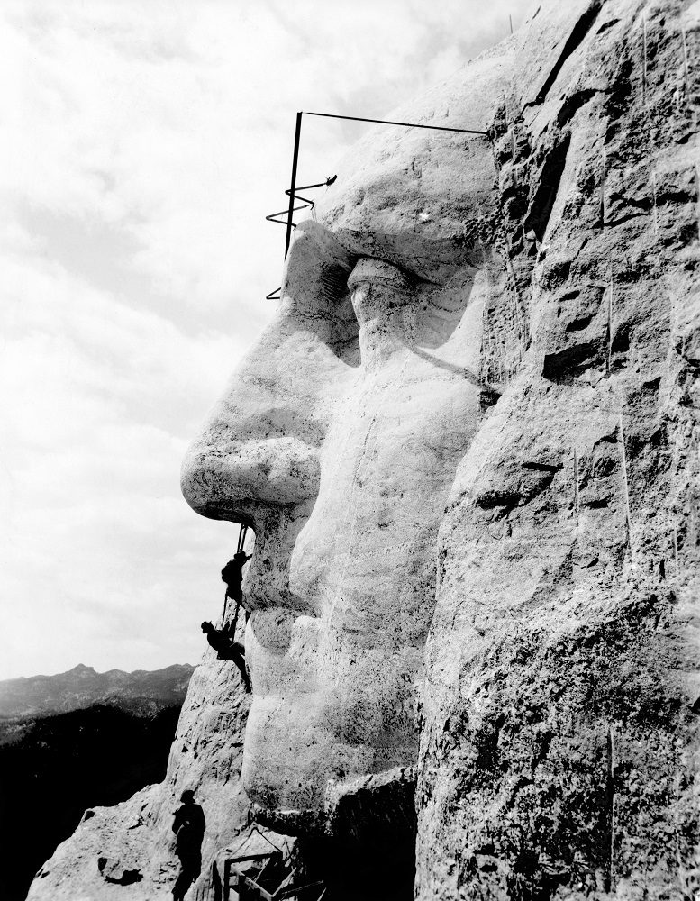 Working on Mount Rushmore. Danish-American sculptor Gutzon Borglum (1867-1941) inspecting the nose of George Washington during the carving of the Mount Rushmore National Memorial.